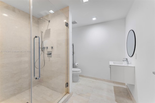 bathroom featuring a shower with door, vanity, tile patterned floors, and toilet