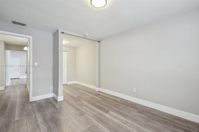 empty room with light hardwood / wood-style flooring