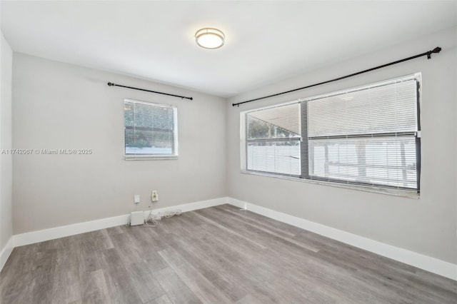 empty room with light hardwood / wood-style flooring