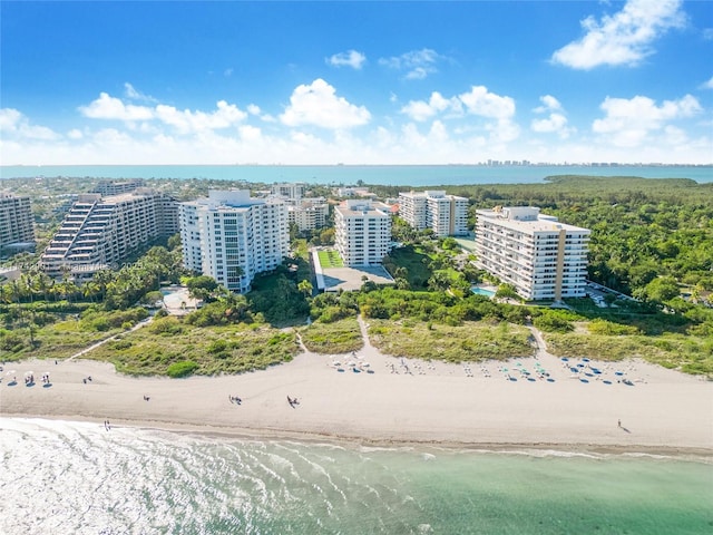 drone / aerial view with a beach view and a water view