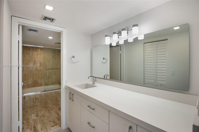 bathroom with vanity and tiled shower / bath combo