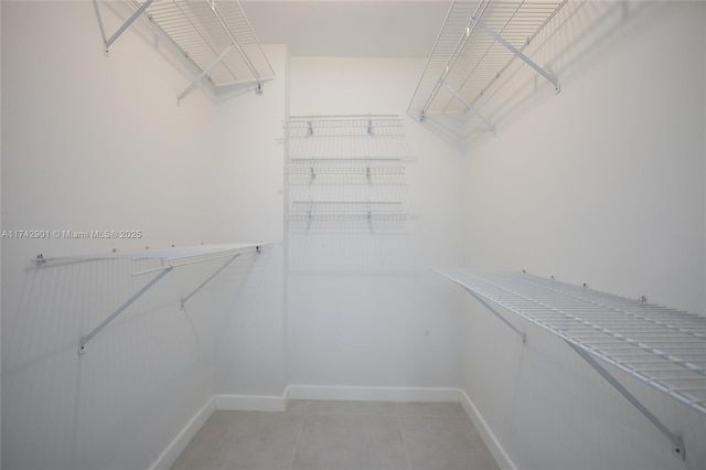 spacious closet featuring light tile patterned flooring