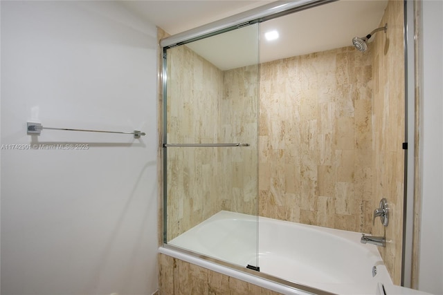 bathroom featuring bath / shower combo with glass door