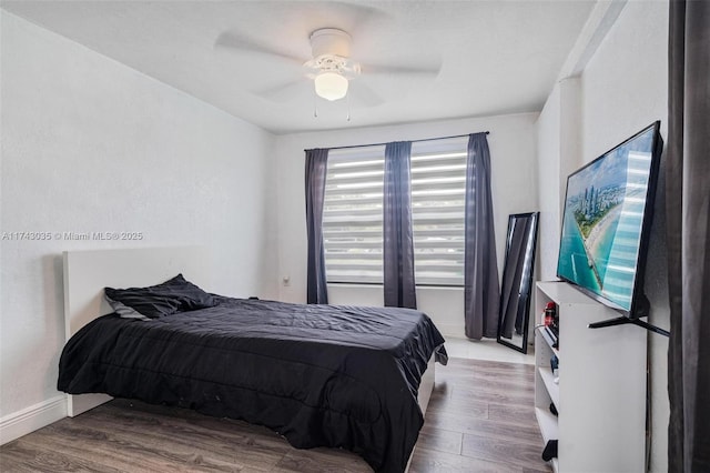 bedroom with light hardwood / wood-style floors and ceiling fan