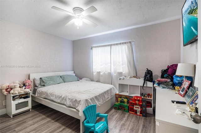 bedroom featuring hardwood / wood-style flooring, ceiling fan, and a textured ceiling