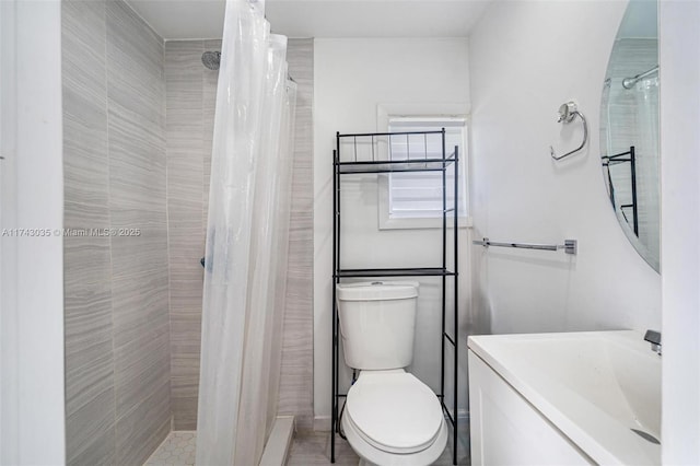 bathroom featuring vanity, a shower with shower curtain, and toilet