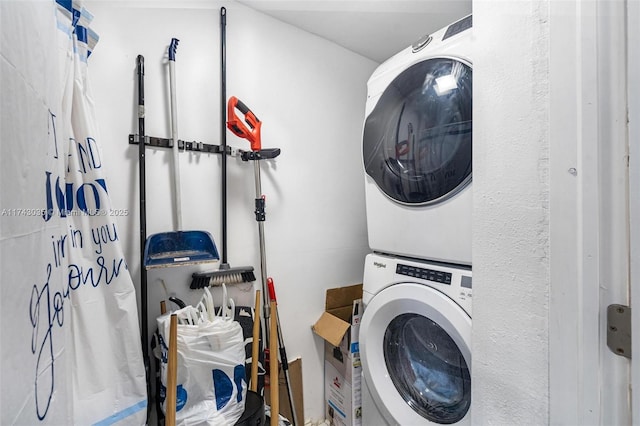 clothes washing area with stacked washer and clothes dryer