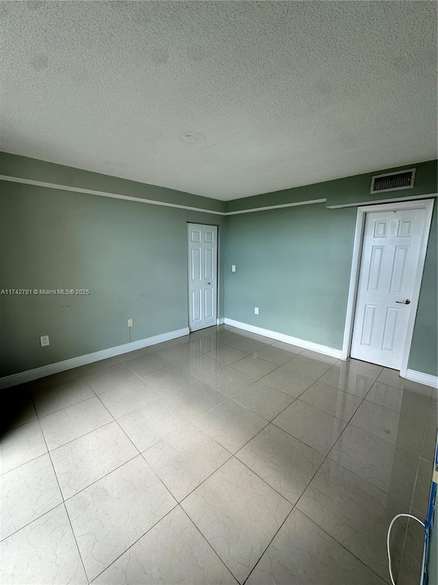 empty room with a textured ceiling