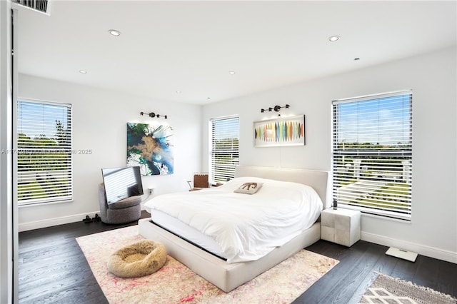 bedroom with dark wood-type flooring