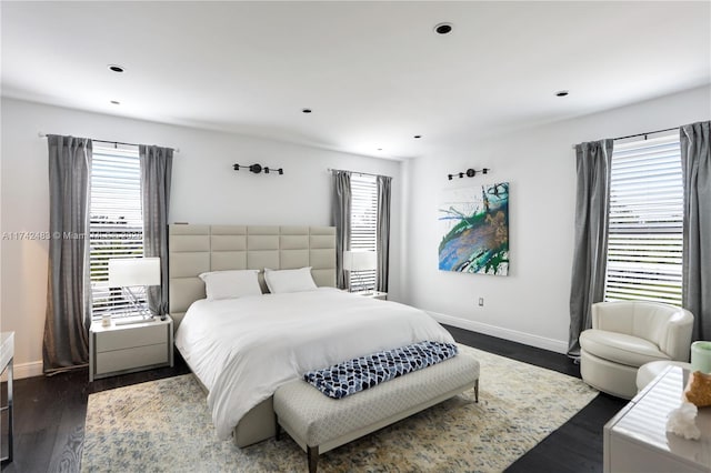 bedroom with dark hardwood / wood-style flooring