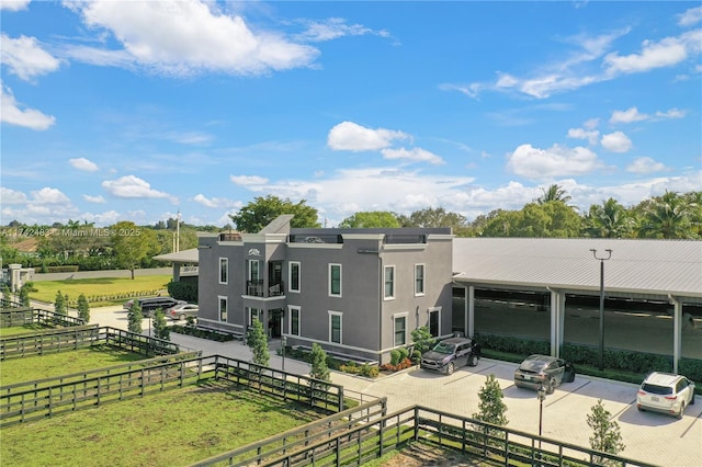 back of house with a rural view and a patio area