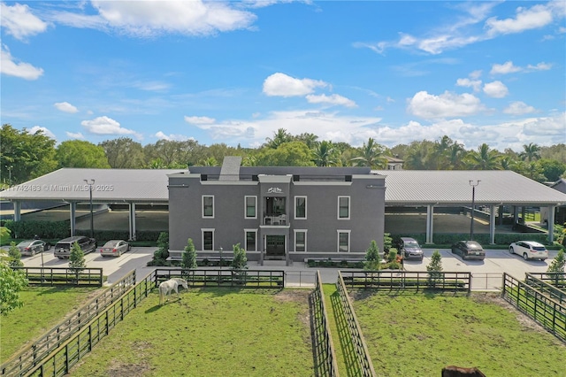 rear view of property with a lawn