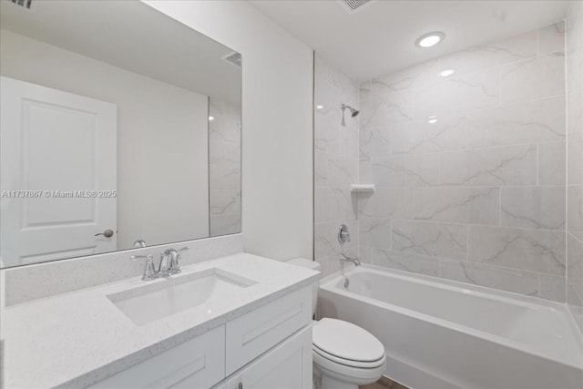 full bathroom featuring vanity, toilet, and tiled shower / bath