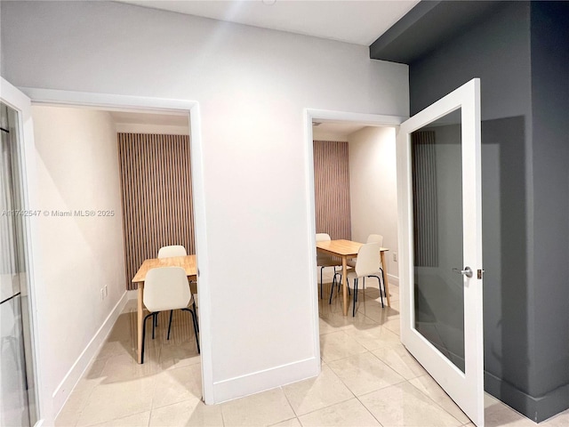 interior space featuring light tile patterned floors and french doors