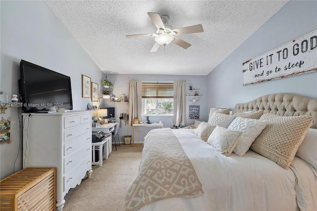 carpeted bedroom with ceiling fan, lofted ceiling, and a textured ceiling