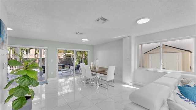 dining space with a textured ceiling