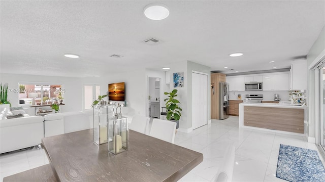 dining space featuring a textured ceiling