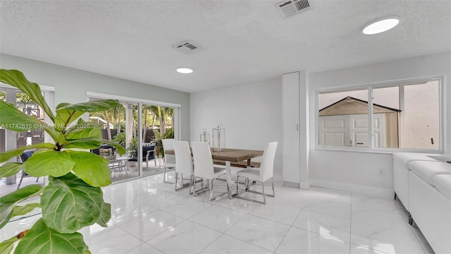 dining area with a textured ceiling