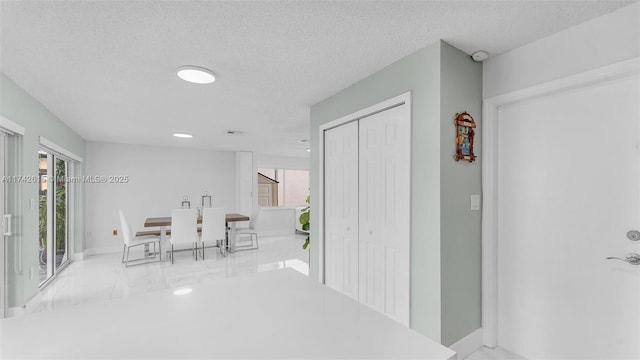 hallway with a textured ceiling