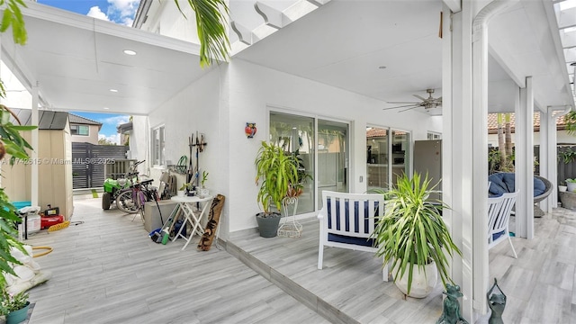 wooden terrace featuring ceiling fan