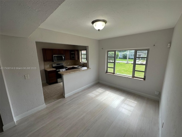 interior space featuring a textured ceiling and light wood-type flooring