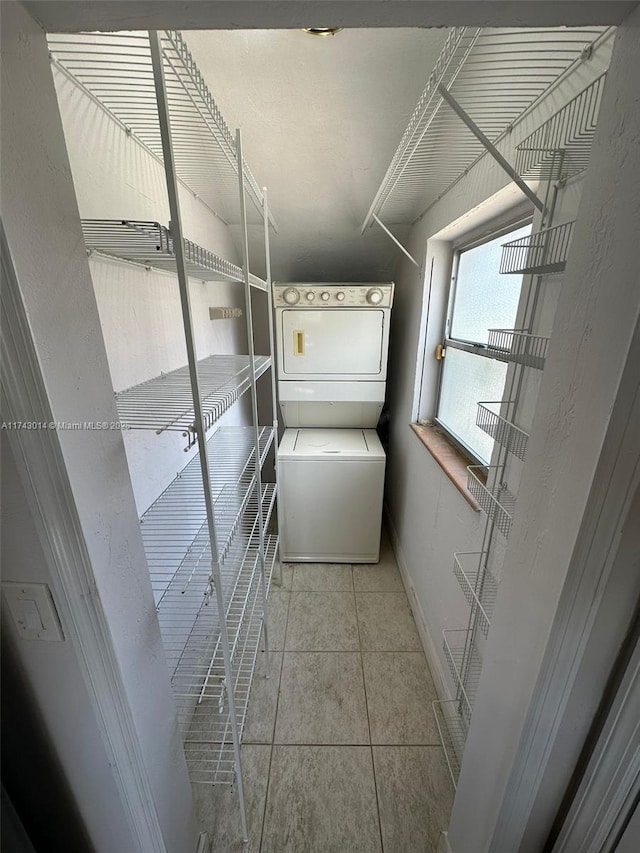 storage room with stacked washer and dryer