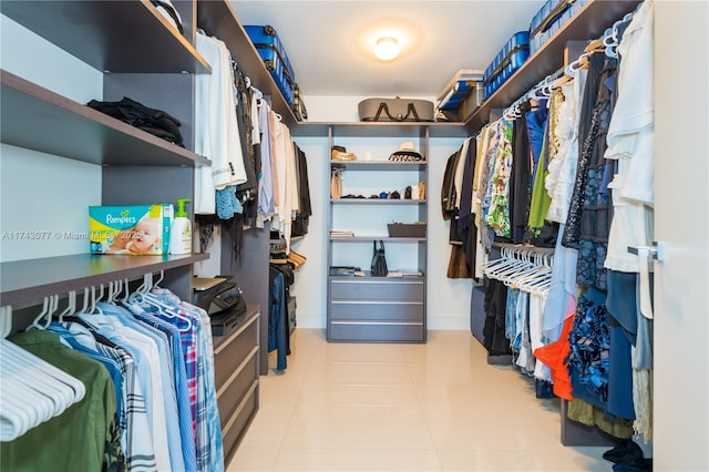 spacious closet featuring light tile patterned floors