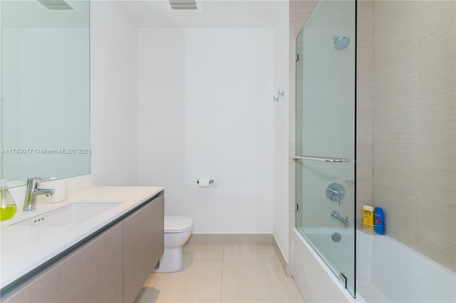 full bathroom featuring tile patterned flooring, vanity, shower / bath combination with glass door, and toilet