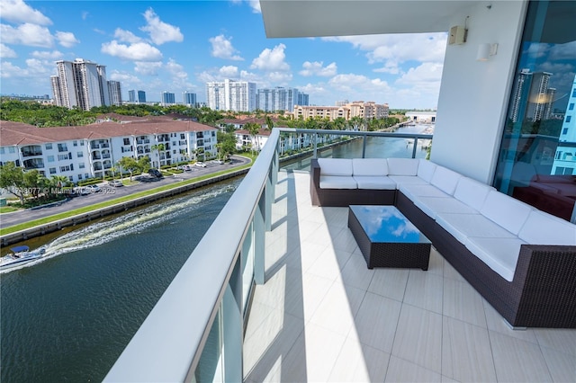 balcony featuring outdoor lounge area and a water view