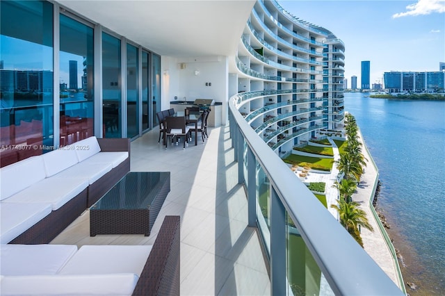 balcony with a water view and outdoor lounge area