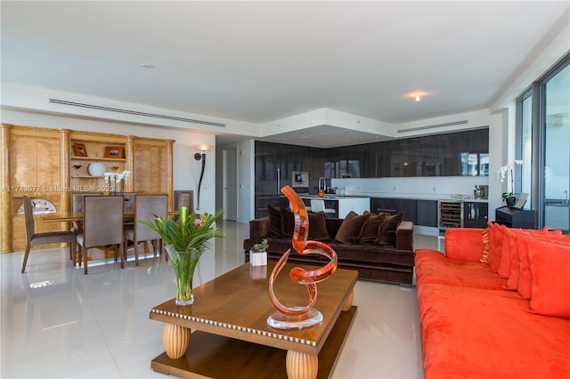 tiled living room featuring wine cooler and sink