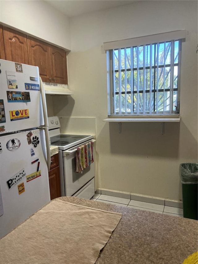 kitchen with tile patterned floors and white appliances