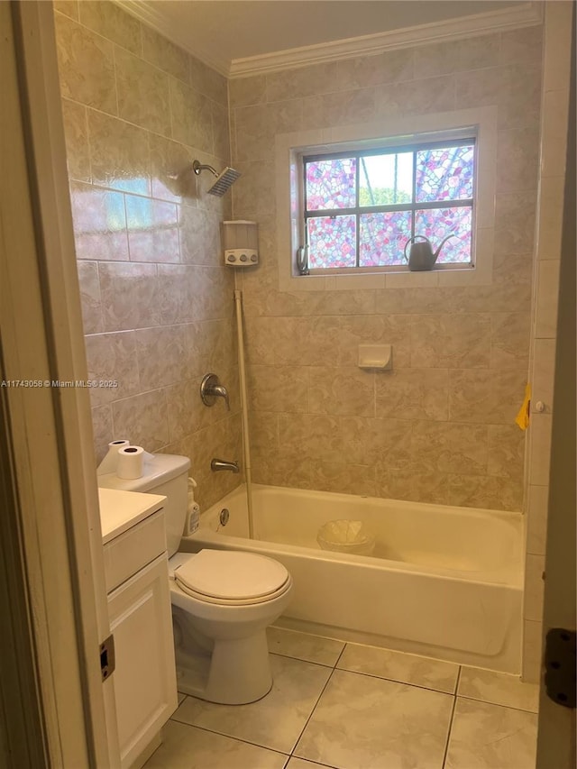 full bathroom featuring tile patterned floors, toilet, ornamental molding, vanity, and tiled shower / bath combo