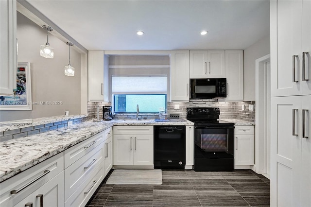 kitchen with sink, hanging light fixtures, tasteful backsplash, black appliances, and white cabinets