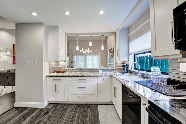 kitchen with sink, white cabinets, hanging light fixtures, black appliances, and light stone countertops