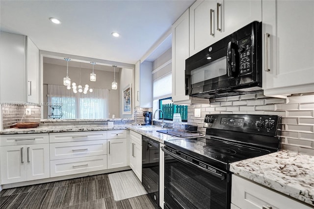 kitchen featuring sink, decorative backsplash, black appliances, and white cabinets