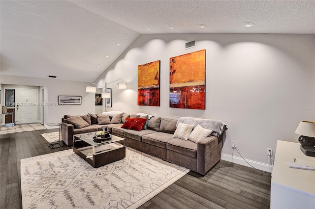 living room with lofted ceiling, dark hardwood / wood-style flooring, and a textured ceiling