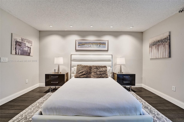 bedroom featuring dark wood-type flooring and a textured ceiling