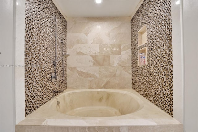 bathroom featuring tiled tub