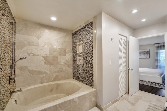 bathroom featuring a relaxing tiled tub