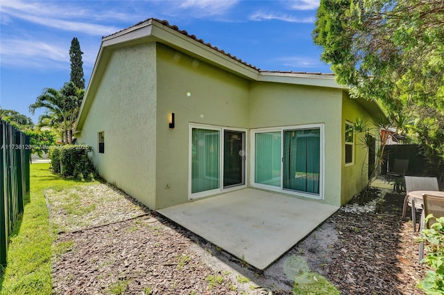 rear view of property featuring a patio