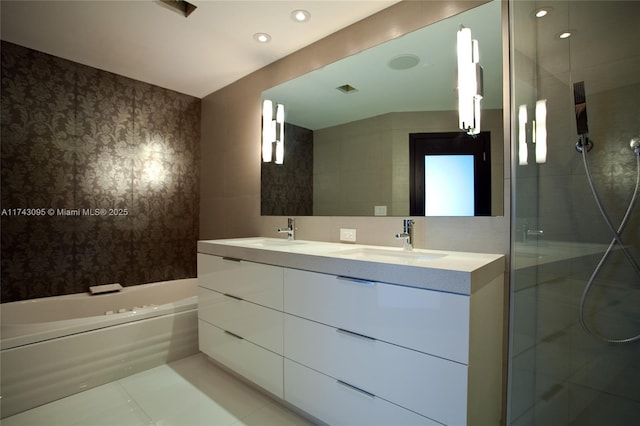 bathroom with tile walls, vanity, tasteful backsplash, and tile patterned floors