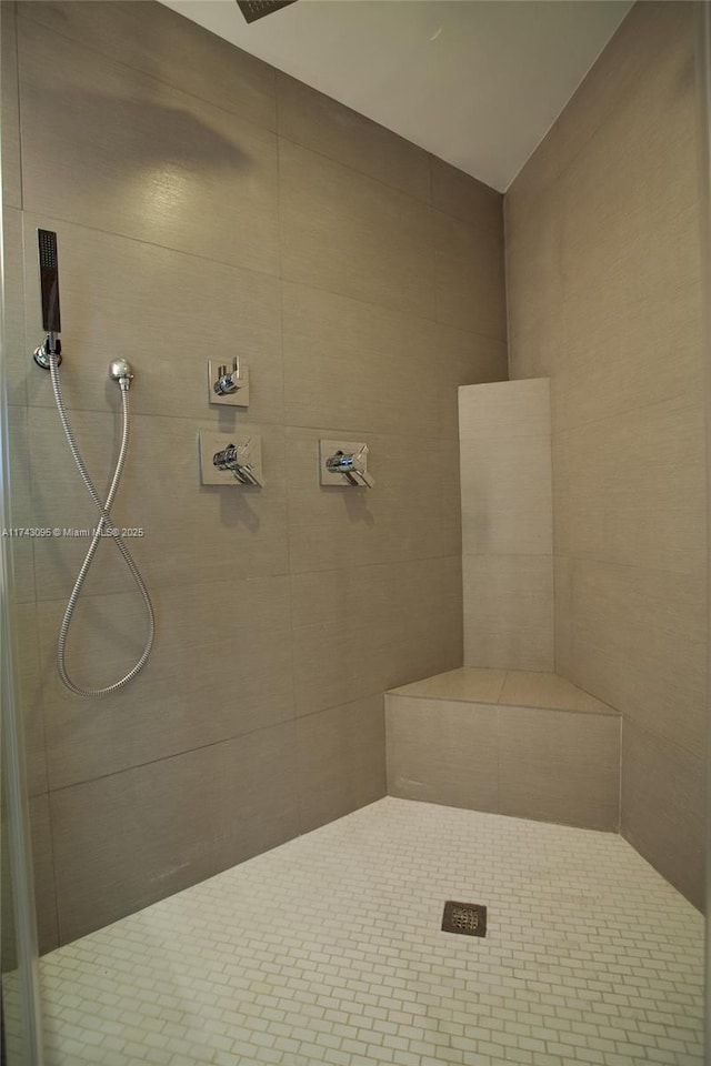 bathroom with tiled shower