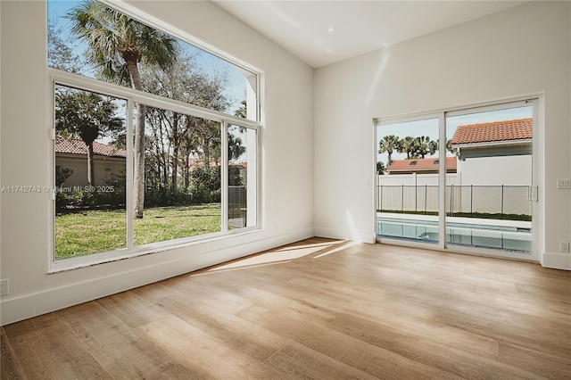 unfurnished room with a healthy amount of sunlight and light wood-type flooring