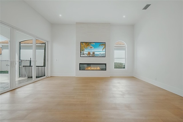 unfurnished living room featuring light hardwood / wood-style floors