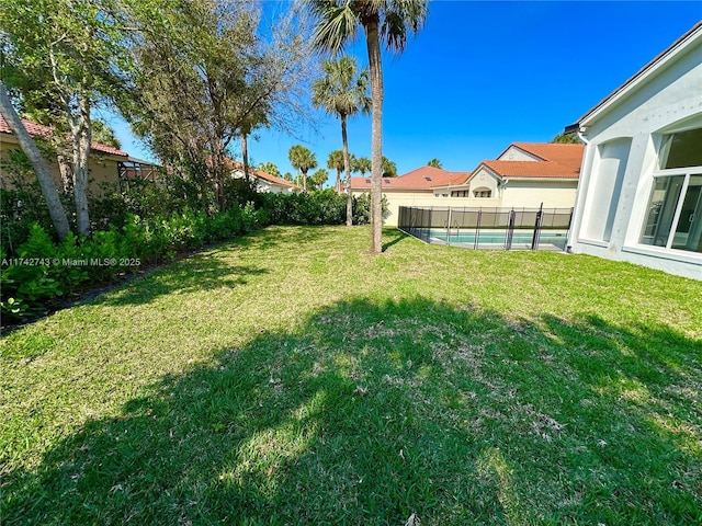 view of yard with a fenced in pool