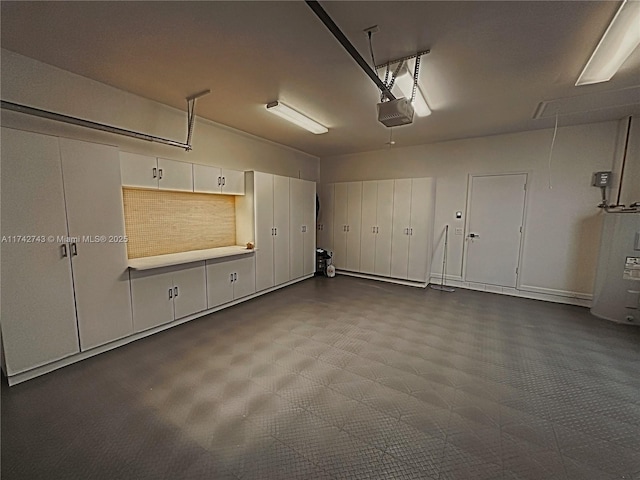 garage featuring a garage door opener and electric water heater