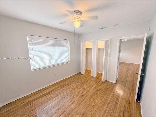 unfurnished bedroom with ceiling fan and light wood-type flooring