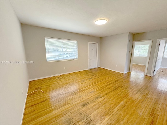 unfurnished room with light wood-type flooring