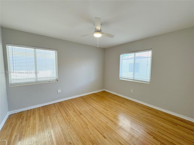 empty room featuring ceiling fan and light hardwood / wood-style flooring